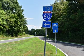 Interstate 80 trailblazer referencing the entrance ramp from the Knowlton Tourist Information Center I-80 eastbound. The rest area includes a picnic area east of this assembly.