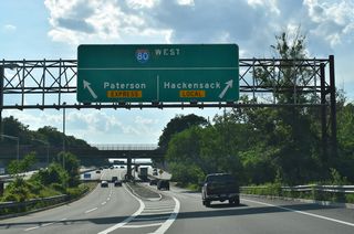 Traffic partitions for the I-80 local and express lanes west at the Teaneck Road (CR 39) over crossing. Interstate 80 comprises a major commuter route from New York City west through the North Jersey suburbs. The freeway continues west from Teaneck 456 miles to Cleveland, 780 miles to Chicago, 1,237 miles to Omaha, and 2,171 miles to Salt Lake City, Utah.