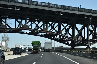 The Turnpike West Spur passes over U.S. 1/9 Truck (Raymond Boulevard) and below U.S. 1/9 (Pulaski Skyway).