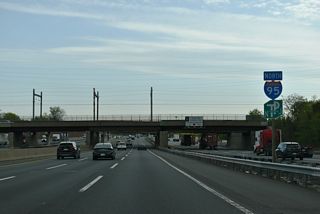 Confirming markers for I-95 and the NJ Turnpike posted ahead of the Fulton Street overpass and New Jersey Coast Line railroad.