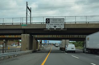 The Outer Roadway northbound expands to four lanes where the left lane becomes HOV-3 restricted.