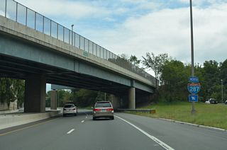 Interstate 287 curves northeastward and straddles Campgaw Mountain through northern Franklin Lakes.