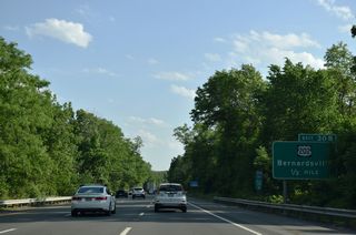 The three quarter cloverleaf interchange at Exit 30 joins Interstate 287 with Maple Avenue, south of the intersection with U.S. 202 (Morristown Road) and Childs Road (CR 613) at Van Dorans Mill.
