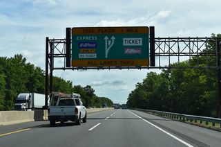 Constructed in 2005, the Exit 1 Toll Plaza was built two miles east of the separation with U.S. 40 to offset traffic overflow onto Interstate 295 during times of peak congestion, such as those during holiday travel periods. The previous plaza was located just ahead of this sign bridge to the west.