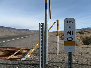 The Nevada Department of Transportation (NDOT) uses white mile markers as references along the state route system. While similar to those found in California, newer mileposts include a graphic of the corresponding route above a two letter county code.
