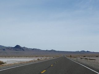 Long, flat stretches of highway between mountain passes are common along U.S. 6 across Nevada, including dry lakebeds such as the Columbus Salt Marsh.