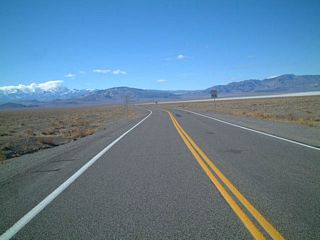 Westbound U.S. 6 leaves the U.S. 95 junction at Coaldale Junction. In the distance, the tall mountain with clouds around the top is Boundary Peak.  U.S. 6 travels over the Montgomery Pass to the north of Boundary Peak. Photo taken 1/20/02.