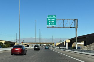 Traffic enters I-11/U.S. 93-95 from I-215 at the Auto Show Road overpass, one mile from Exit 64 A to Sunset Road.