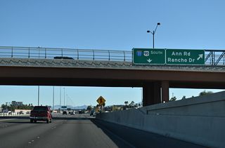 The flyover joining CC-215 west with I-11/U.S. 95 south includes a slip ramp to the c/d roadway (Exit 91 B) leading to Ann Road and U.S. 95 Business (Rancho Drive).