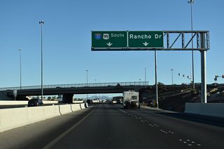 Unmarked along I-11/U.S. 95, Rancho Drive is U.S. 95 Business/SR 595. The pre-freeway alignment of U.S. 95 angles southeast to North Las Vegas Airport (VGT), returning to Interstate 11 at Exit 77.