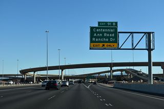 Exit 91 B departs from within the Centennial Bowl interchange as a collector distributor roadway with ramps to Centennial Center Boulevard, Ann Road and Rancho Drive (SR 595).