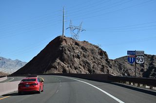 I-11/U.S. 93 south enter a long sweeping S-curve ahead of the Mike O' Callaghan-Pat Tillman Memorial Bridge over the Colorado River.