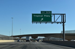 I-15/U.S. 93 spans a Union-Pacific railroad line and N Range Road where Exit 52 B departs for Tropical Parkway. Tropical Parkway ties into E Centennial Parkway to the north and N Hollywood Boulevard to the east.