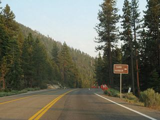 Southbound Nevada 28 approaches Sand Harbor beach (next right).