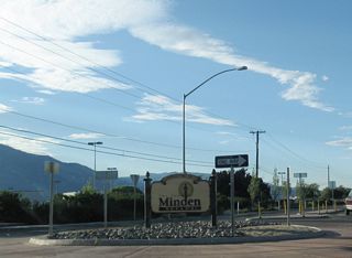 A welcome sign for the town of Minden is posted in the middle of the roundabout.