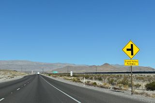Grand Valley Parkway stems southwest from U.S. 93 at a partial grade separated intersection where the southbound roadway is elevated.