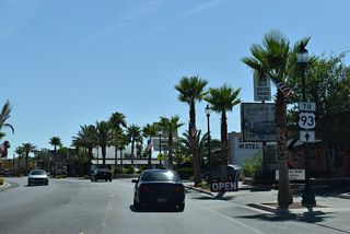 A U.S. 93 trailblazer stands along Nevada Way east between Elm Street and 5th Street. Nevada Way angles northeast through the Boulder City Historic District before turning to U.S. 93 Business (Boulder City Parkway).