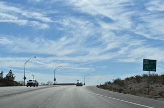 Boulder City Parkway angles southwest from Industrial Road to the signalized intersection with Nevada Way east and Buchanan Boulevard south.