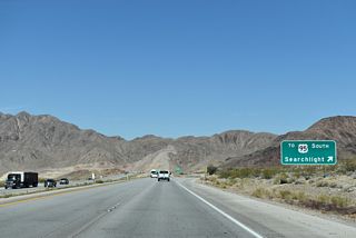 SR 173 follows old U.S. 95 south 1.08 miles to the parclo interchange where U.S. 93 separates from I-11/U.S. 95 south to Searchlight.