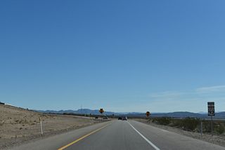 A superfluous trailblazer for U.S. 93 Business stands along the southbound exit ramp to SR 173 (Veterans Memorial Highway).