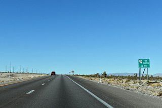 SR 156 angles southwest to Lee Canyon in the Spring Mountains one half mile ahead.