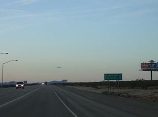Advancing north from the west end of SR 163 and the settlement of Palm Gardens, U.S. 95 travels 19 miles to Searchlight.