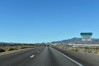 The speed limit lowers along U.S. 95 north ahead of Creech Air Force Base (AFB) at Indian Springs. The highway divides the base and the unincorporated town.