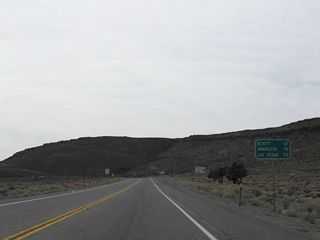 SR 374 (Main Street) in Beatty is 65.7 miles south of this distance sign posted outside Goldfield.