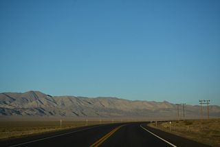 U.S. 95 curves southeast ahead of Mineral County mile marker 27. The Gabbs Valley Range borders Soda Spring Valley to the east.