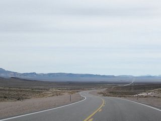 U.S. 95 navigates through an S-curve southeast from Stonewall Pass onto Sarcobatus Flat.