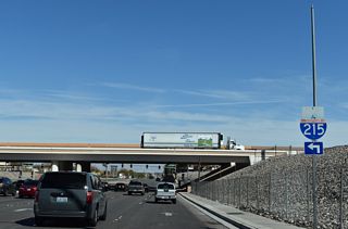 Interstate 215 arcs northwest from Henderson toward Harry Reid International Airport (LAS) in Paradise.