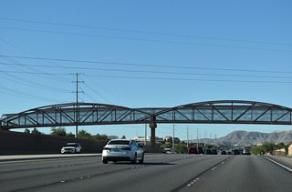 A pedestrian bridge takes Saint Rose Parkway Trail across SR 146 by Cactus Wren Park.