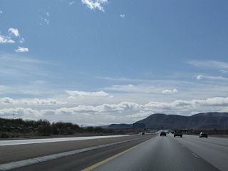 Nevada 146 carries four through lanes in each direction plus auxiliary turn lanes.