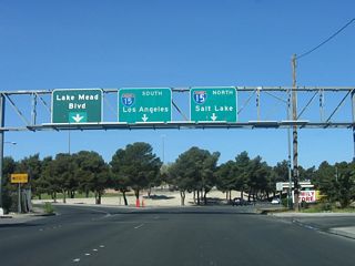 An overhead sign is posted at the west end of Nevada 147. The left lane continues west on Lake Mead Boulevard, while the right two lanes connect to Interstate 15. With the coming reconstruction of Interstate 15 north of U.S. 95 and Interstate 515, it is not clear if this interchange will retain its existing configuration.