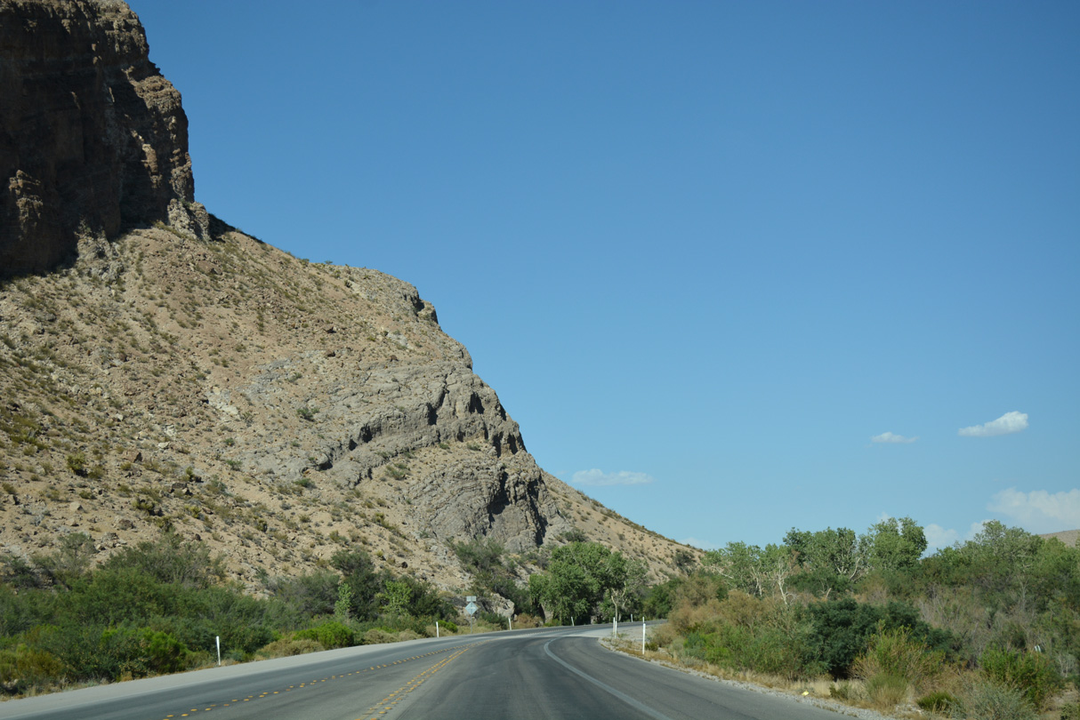 Arroyo Road ties into SR 159 east from Blue Diamond at a gap between adjacent hills.