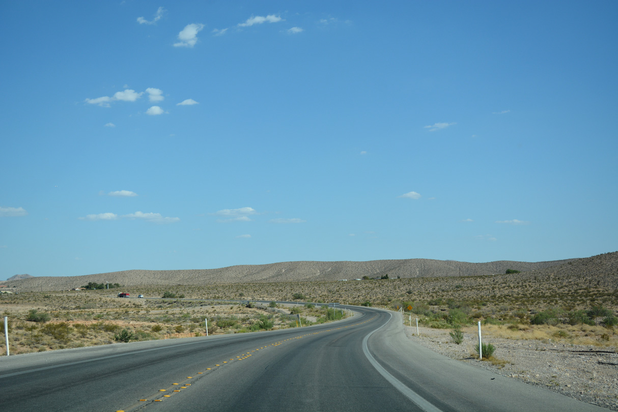 Turning south, SR 159 navigates through an S-curve across an unnamed wash.