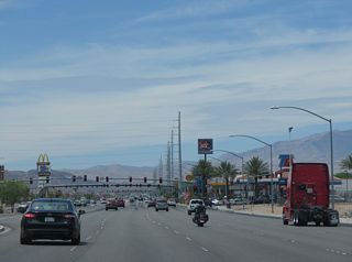 SR 160 (Blue Diamond Road) advances southwest from Interstate 15 along a commercialized stretch.
