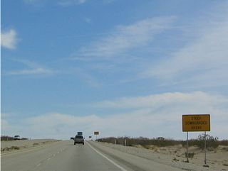 Signs advise motorists of the upcoming descend along SR 163 toward the Colorado River valley.
