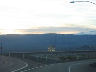Westbound Nevada 163 approaches the junction with U.S. 95 -- turn left for U.S. 95 south to Needles or right for U.S. 95 north to Searchlight, Boulder City, and Las Vegas.