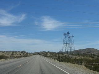Two of the companion 230kV are the same power lines that cross Interstate 40 at Water Road in the Mojave Desert. Power lines tend to travel great distances to connect power generating facilities with population areas. These lines are likely to be owned by the Los Angeles Department of Water and Power. A third 230kV power line (single circuit, not shown) is likely owned by Nevada Power.