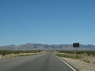 A mileage sign on Valley of Fire Highway east advises of the fees charged at the Valley of Fire State Park.