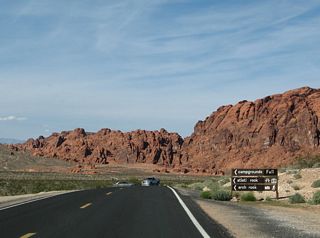The access road to Atlatl Rock, Arch Rock and associated campgrounds stems west from Valley of Fire Highway. Petroglyphs are engraved into Atlatl Rock.