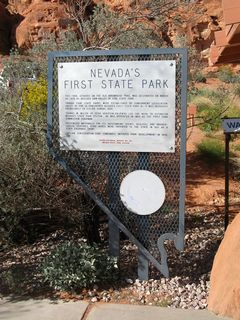 The Valley of Fire Vistors Center is designed to blend into the surrounding fiery landscape. A monument to the state of Nevada's first state park is placed next to the visitor's center entrance.