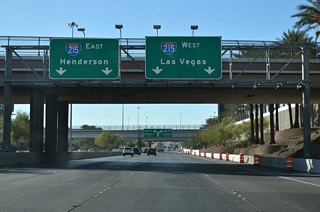SR 171 south (Airport Connector) passes under Grier Drive in advance of a trumpet interchange with I-215 (Bruce Woodbury Beltway). 