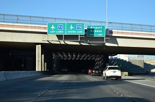 SR 171 north ends where the Airport Connector enters the tunnel system below runways at Harry Reid International Airport (LAS). Guide signs at Sunset Road partition motorists bound for Terminals 1 and 3 ahead of the tunnel.
