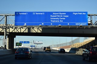 Emerging from the tunnel, ramps separate from the Airport Connector for Terminals 1 and 3 of LAS Airport. This section northward is also inventoried as a part of Paradise Road.