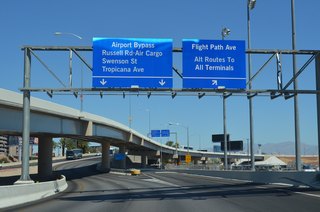 The northbound lanes of the Airport Connector (Paradise Road) shift under the ramp to Terminal 3 where the exit departs for Flight Path Avenue. Flight Path Avenue serves as a connector road between Terminals 1 and 3.