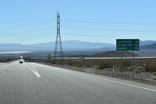 A distance sign from when this section of Veterans Memorial Highway was still U.S. 95 precedes the intersection with Silverline Road.