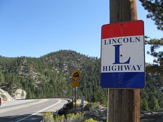 Adjacent to the Daggett Pass sign is a Lincoln Highway trailblazer for those following an early alignment of the famed historic highway. Photo 09/07/09.
