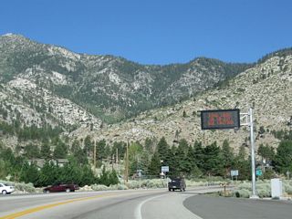 Upon leaving the intersection with Nevada 206 (Foothill Road), westbound Nevada 207 (Kingsbury Grade) passes under a variable message sign to warn of any traffic, weather conditions, or construction activities that might cause delays over Daggett Pass.